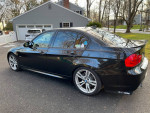 2011 BMW 335i xDrive 6 Speed in black color parked outdoors, showcasing sporty design and alloy wheels