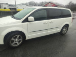 2010 Dodge Grand Caravan shown in white with third-row seating and clean exterior.