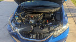 Under the hood of a 2013 Honda Civic EX showcasing the engine and components, well-maintained with service records.