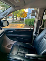 Interior view of a 2014 Chrysler Town & Country showcasing black leather seats and dashboard.