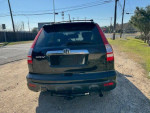 Rear view of a black 2007 Honda CR-V EX parked, showcasing its SUV design and clean condition.