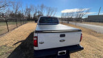 Rear view of a 2011 Ford F250 King Ranch FX4 truck for sale, showcasing its bed cover and clean condition.