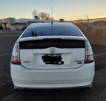2007 Toyota Prius rear view, mileage around 146,000, showing wear with tinted windows needing replacement.
