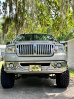 Front view of a 2006 Lincoln Mark LT in mint condition, showcasing its chrome grille and lifted suspension.