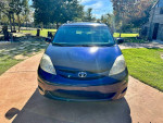 2006 Toyota Sienna LE minivan in blue, featuring leather seats and front wheel drive, parked outdoors.