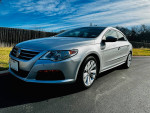 2011 Volkswagen CC Sport in silver color, showcasing sleek design and great condition against a clear blue sky.