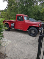 1951 Willys Jeep Pickup Truck in red, 2-door with vintage design and minimal rust.