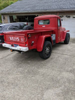 1951 Willy's Jeep Pickup Truck in red, showcasing clean lines and vintage features for sale.