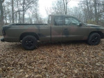 1997 Dodge Dakota Sport 4WD in a forest setting, showcasing its unique camouflage exterior and low mileage.