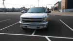 2012 Chevrolet Silverado 1500 LT 4WD parked in a lot, showcasing its front view and chrome grille.