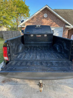 Rear view of a 2018 Ram 3500 Big Horn truck bed showing black lining and towing hitch.