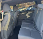Interior view of 2016 Kia Sedona LX with beige seats and spacious design, ideal for families.