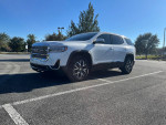 2021 GMC Acadia SLE FWD in excellent condition, parked under clear blue sky, showcasing its stylish design.