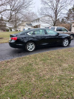 2015 Chevrolet Impala with black leatherette interior and moon roof parked on a residential street