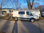 2017 Ford Transit 250 cargo van parked at a residence, well-maintained with 125k miles, for sale at $16,900.