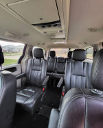 Interior view of a 2014 Chrysler Town & Country Mini Van with black leather seats