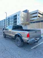 2005 Ford F-350 King Ranch 4x4 truck in a parking lot, showcasing its rugged design and aftermarket features.
