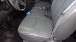 Interior view of a Chevy Silverado showing clean gray seats and dashboard in great condition.