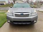 Front view of a 2011 Subaru Outback 2.5i AWD, showcasing its sleek design with rain droplets.