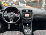 Interior view of a 2011 Volkswagen Golf with navigation system and heated seats