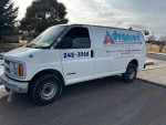 1999 Chevrolet Express van with logo, runs great, has shelves and bins, showing minor cosmetic imperfections.