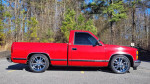 1989 Chevrolet C1500 Silverado pickup truck in red color parked in a natural setting