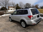 2011 Subaru Forester 2.5X AWD parked showing sleek design, sunroof, and good tire condition.