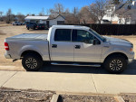 2004 Ford F150 XLT truck in silver with new engine and tires, parked outdoors.