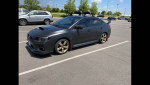 2015 Subaru WRX Limited AWD in shadow black with gold wheels parked, showcasing its sporty design and modifications.