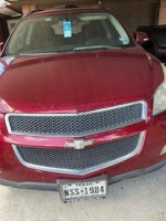 Front view of a 2011 Chevrolet Traverse LS in burgundy with dark gray interior and Texas license plate.
