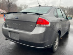 2011 Ford Focus SE sedan parked, featuring a clean exterior and rear view, showcasing alloy wheels and no visible damage.