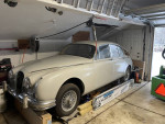 1960 Jaguar MK2 in garage, partially restored with new interior and refurbished chassis, priced for sale.