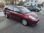2010 Toyota Sienna LE in excellent condition, 7-passenger seating, FWD, alloy wheels, parked in residential area.