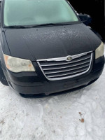 2009 Chrysler Town & Country van in good mechanical condition with functional features, parked in snow.