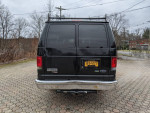 Rear view of a well-maintained 2010 Ford E350 XLT Cargo van with towing package and backup camera.
