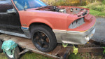 Red 1987 Ford Mustang GT parts car with minimal rust, no engine or interior, suitable for drag racing.