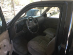 Interior of a Tacoma pickup truck showing steering wheel and seats with visible control panel