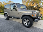2005 Jeep Wrangler Rubicon 4WD in Light Khaki Metallic, ideal for off-roading and collectors.