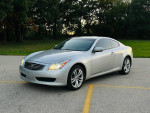2009 INFINITI G37X AWD Coupe parked in a scenic outdoor setting, showcasing sleek silver design and low mileage.
