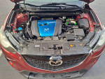 Under the hood of a 2013 Mazda CX5 showing the engine components and features.