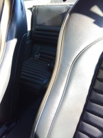 Interior view of a 2000 Ford Mustang showing plush leather seats and rear seating area.