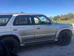 2002 Toyota 4Runner SUV in tan color parked outdoors, showcasing its sleek design and good condition.