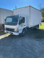 2010 Mitsubishi Fuso box truck with lift gate parked outdoors