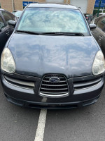 2007 Subaru Tribeca in grey parked, showing details of front grille and headlights, 131K miles, needs towing.