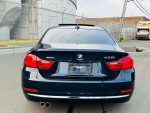 Rear view of a 2014 BMW 4 Series 428i RWD, showcasing sleek design and XDrive badge.