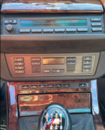 Interior dashboard of a 2006 BMW X5 3.0i with manual transmission and climate control features.