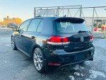 2013 Volkswagen GTI Driver's Edition in black with alloy wheels, parked in an outdoor setting.