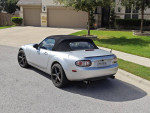2006 Mazda MX5 Miata in silver parked on a driveway, showcasing sporty design and low mileage of 49,000.