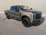 2023 Ford F250 Super Duty Crew Cab with Black Appearance Package and tinted windows, parked in a lot.