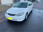 2006 Toyota Camry LE FWD with 119,000 miles for sale, featuring aftermarket sound system.